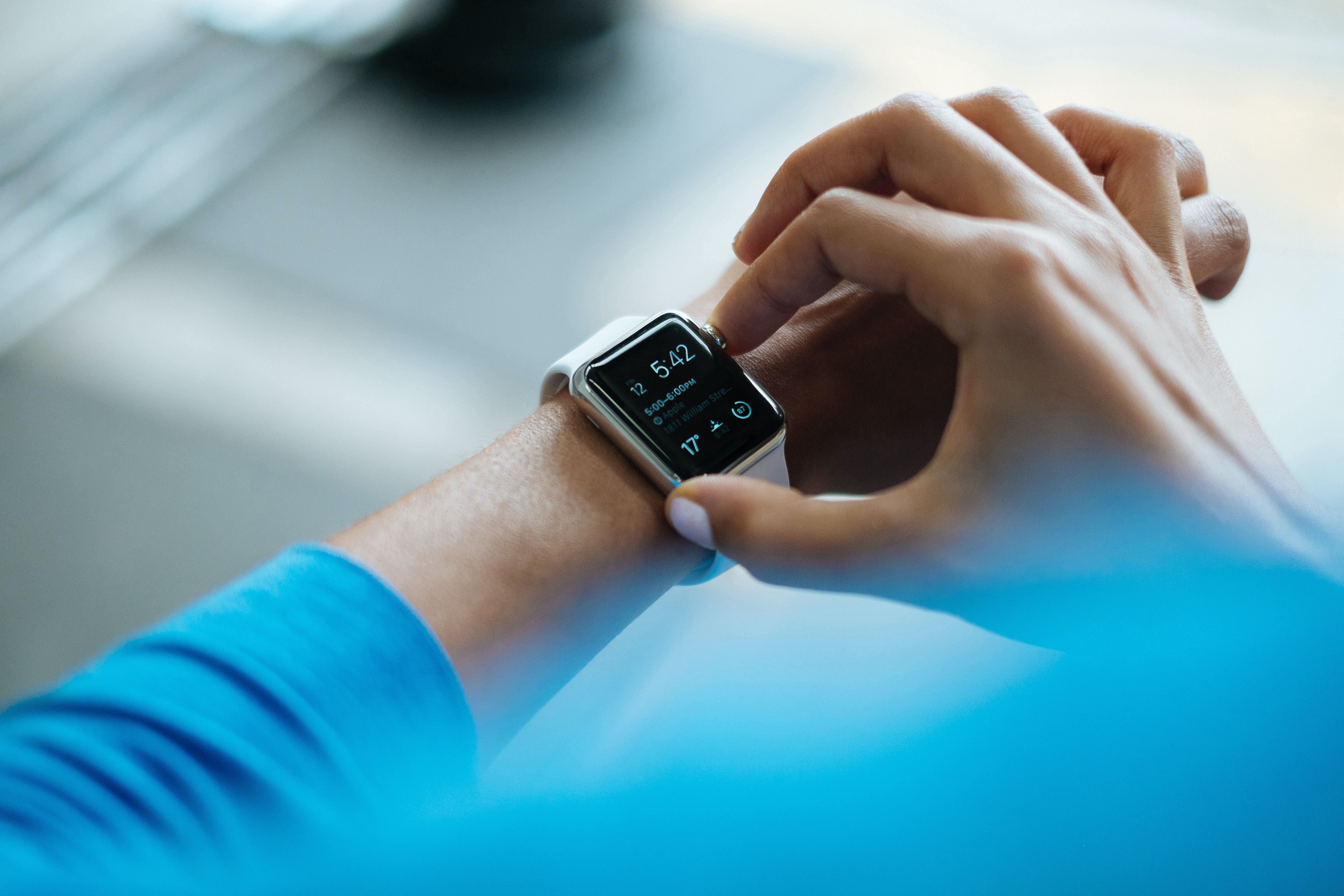 A woman checks her smart watch